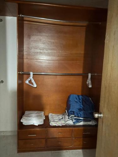 a wooden closet with a bed and two towels at House in Monterrey Nuevo León in Monterrey