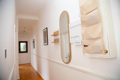 a mirror hanging on a wall next to a hallway at High Street 3BR city views near beach - Groups, Families, Contractors in Bournemouth