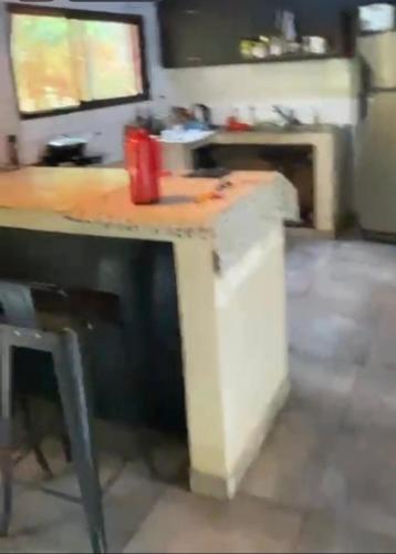 a table in a kitchen with a counter top at Casa roja in Eldorado
