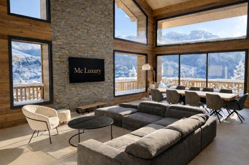 a living room with a couch and a table and chairs at Chalet 1480 in Allos