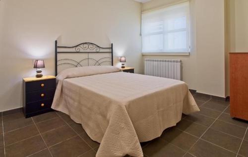 a bedroom with a large bed and two night stands at Apartamentos turísticos Sardon in Sardón de los Frailes