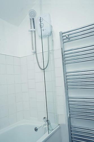 a shower in a bathroom with a bath tub at Contractor & Family Haven, Sleeps 7, Parking & Garden in Wednesfield