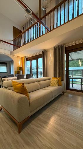 a living room with a large couch in a house at VILLA TOMILLARES in Los Tomillares