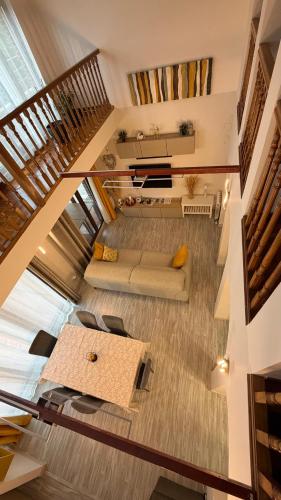 an overhead view of a living room with a staircase at VILLA TOMILLARES in Los Tomillares