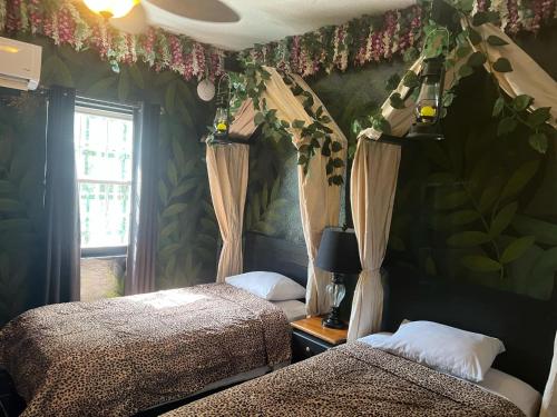 a bedroom with two beds and a window at Belize Budget Suites in San Pedro