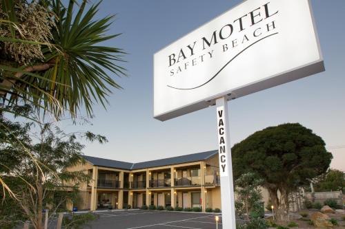 a sign in front of a bay world shopping hotel at Bay Motel Safety Beach in Safety Beach