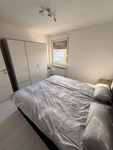 a bedroom with a large bed and a window at Kleines Appartment mit großer Terrasse in Herscheid