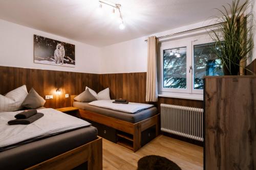 a small room with two beds and a window at Haus Tisch in Schruns