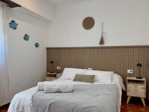 a bedroom with a large bed with white sheets at Hotel Hijos Del Mar - Rincón Costero in Miramar