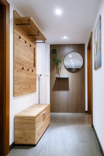 a hallway with a wooden door and a bench at Haus Tisch in Schruns