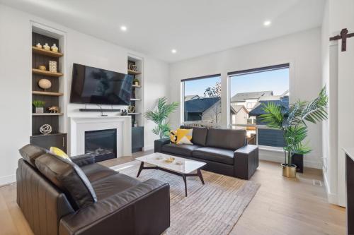 a living room with a couch and a fireplace at Sparsh Villas - Exquisite & Luxurious Family Home in Langley