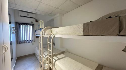 a hospital room with two bunk beds and a hallway at Departamento Frente al Salinas Yacht Club in Salinas