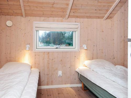 two beds in a room with a window at 6 person holiday home in Toftlund-By Traum in Toftlund
