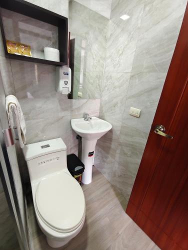 a bathroom with a toilet and a sink at Hotel GM zamora Balcony in Zamora
