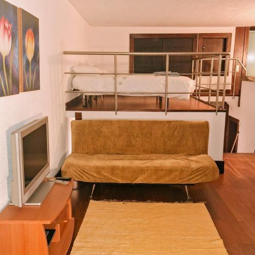 a room with two bunk beds and a television at AL Tróia Penaferrim in Troia
