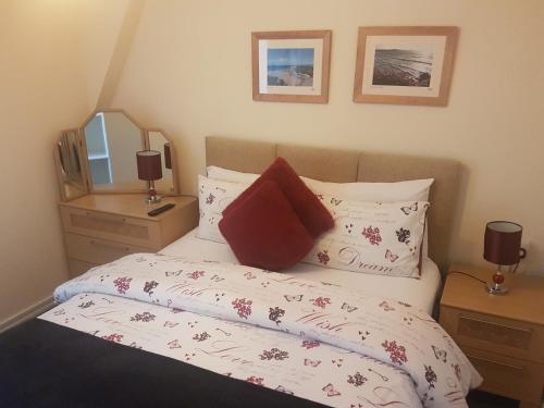 a bedroom with a bed and a mirror at The Trelinda Guest House in Newquay