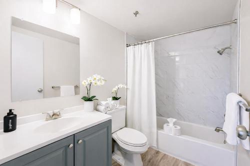 a bathroom with a sink and a toilet and a shower at The Hartford Skyline - Stylish Downtown Condo with Wifi Gym in Hartford