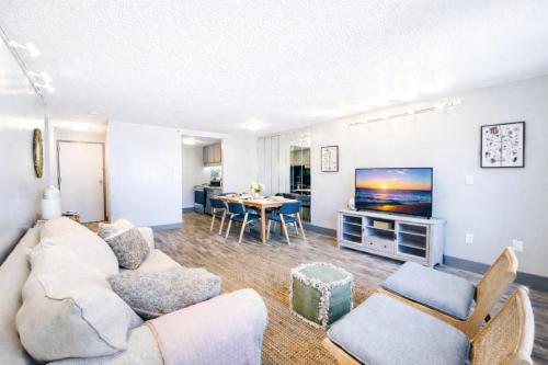 a living room with a couch and a tv at The Hartford Skyline - Stylish Downtown Condo with Wifi Gym in Hartford