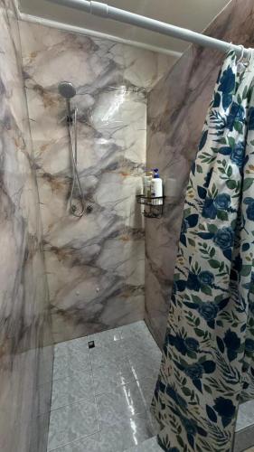 a bathroom with a shower with a shower curtain at hostel family in Santiago