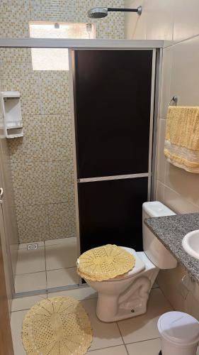 a bathroom with a shower with a toilet and a sink at Casa Temporada Peter in Tutóia