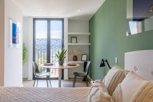 a bedroom with a bed and a table and chairs at Studio Apartment Zona 10 near airport in Estación Pamplona