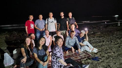 a group of people posing for a picture at night at Heritage Hostel Muscat in Muscat