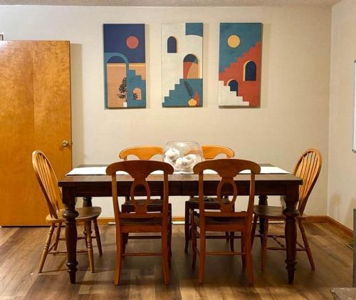 a dining room table with chairs and paintings on the wall at Comfortable 2BR-2BA Mountain Getaway Near Slopes in Cortland