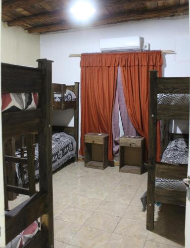 a room with two bunk beds and a curtain at Alalá Campo in Pocito