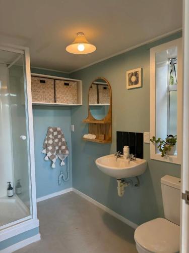 a bathroom with a sink and a toilet at Self-contained studio by the beach in Paekakariki