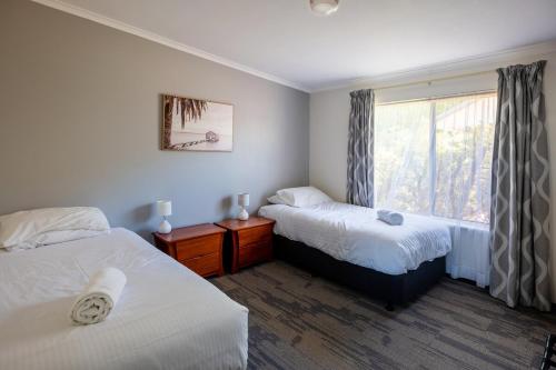 a hotel room with two beds and a window at Middleton Mews in Albany