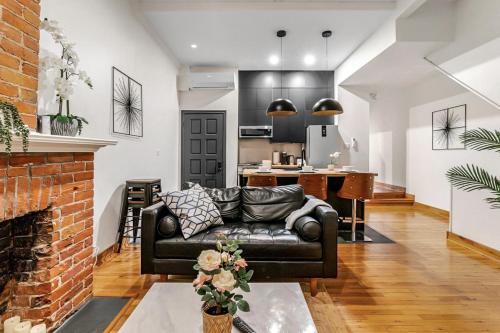 a living room with a couch and a fireplace at Historic Victorian with Deck and Parking in Toronto