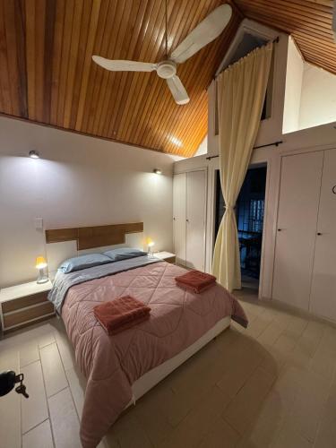 a bedroom with a bed and a ceiling fan at Casa EMMA Girardot in Girardot