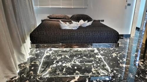 a bed with two pillows on it in a room at PATONG TOWER Residence Apartments 2026 in Patong Beach