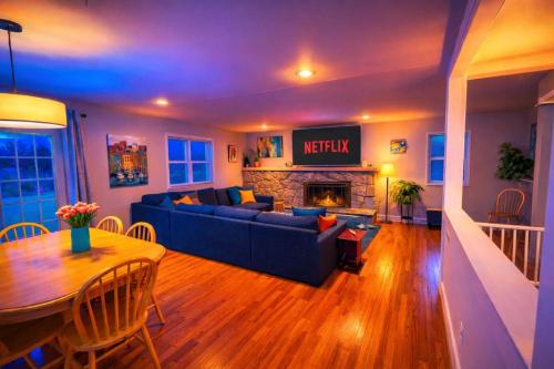 a living room with a blue couch and a fireplace at Large Private Ranch - Master Bedroom Suite with King Bed and private Bathroom - Fenced Yard - Pets & Kids Welcome - Pool Table in Columbus