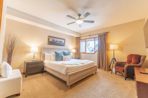 a bedroom with a bed and a ceiling fan at Cascade Penthouse by Canadian Rockies Vacation Rentals in Canmore