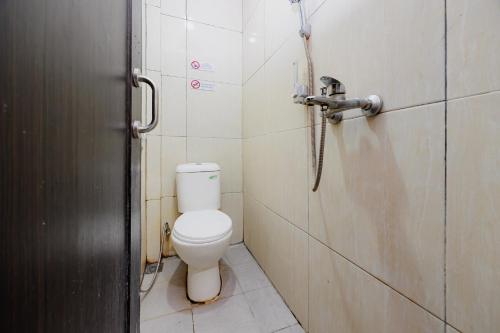 a bathroom with a toilet and a shower at Hotel C18 at Cibaduyut Mitra RedDoorz in Bandung