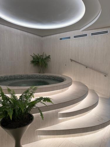 a group of stairs with a tub in a room at Adagio Quito Suite de Lujo in Quito