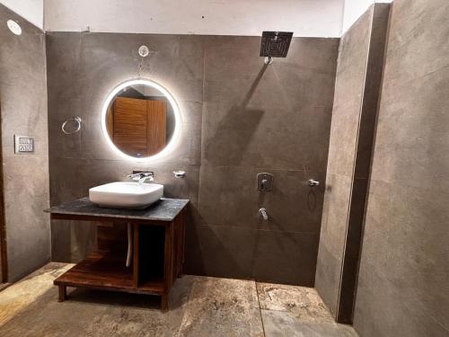 a bathroom with a sink and a mirror at Serene Forest Resort in Nainital