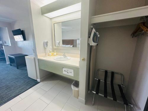 a bathroom with a sink and a mirror at BridgePointe Inn & Suites by BPhotels, Lincoln I-80 & 27th St in Lincoln