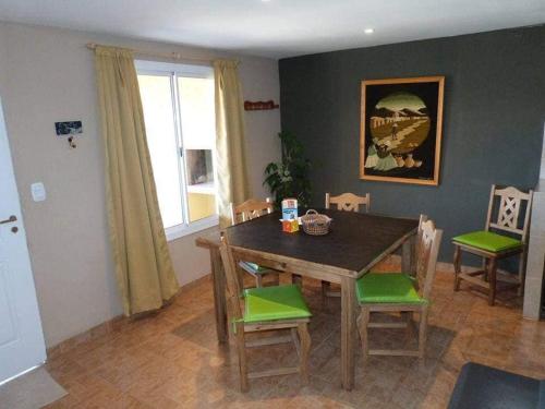 a dining room with a wooden table and chairs at Cabañas el Recodo de Potrero in Potrero de Garay