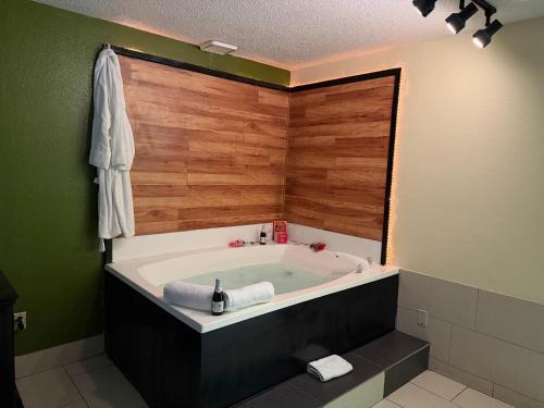 a large bath tub in a bathroom with green walls at Lafayette Inn & Suites in Indianapolis