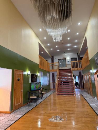 a large lobby with a staircase and a stair case at Lafayette Inn & Suites in Indianapolis