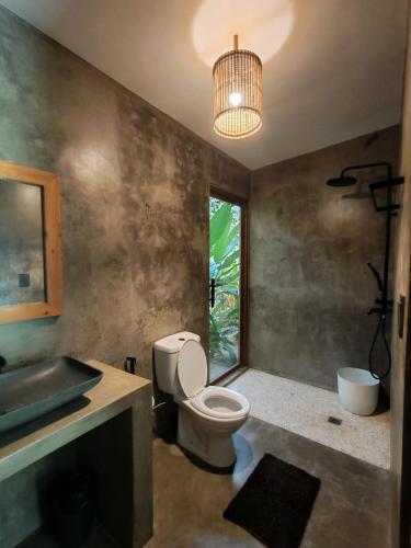 a bathroom with a toilet and a sink at Payapa garden Nagtabon Beach in Puerto Princesa City