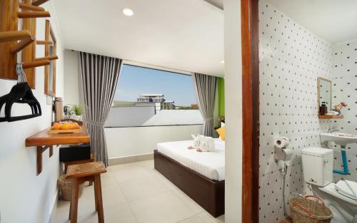 a small bedroom with a bed and a balcony at Stay Siem Reap in Siem Reap