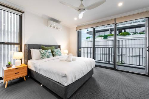 a bedroom with a bed and a large window at Oak & Ivy on Windsor in Williamstown