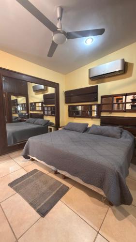 a bedroom with a bed and a ceiling fan at Hacienda en Primavera, descanso Familiar total in Puerto Vallarta