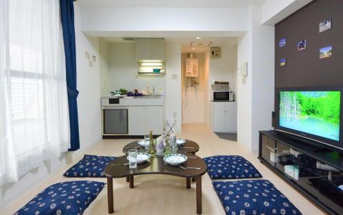 a living room with a table and a television at Carid Shiraishi In front of the station / Vacation STAY 4651 in Sapporo