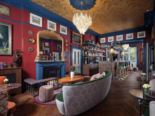 a bar with red walls and a mirror at Bertrand's Townhouse in London
