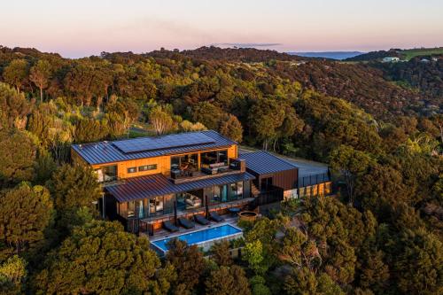an aerial view of a house in the woods at Kaitiaki Lodge - Private pool & Spa in Putiki