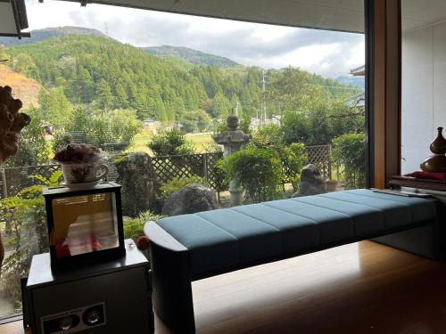 a room with a window with a view of a mountain at Fukuzawa Ryokan - Vacation STAY 39918v in Sakai